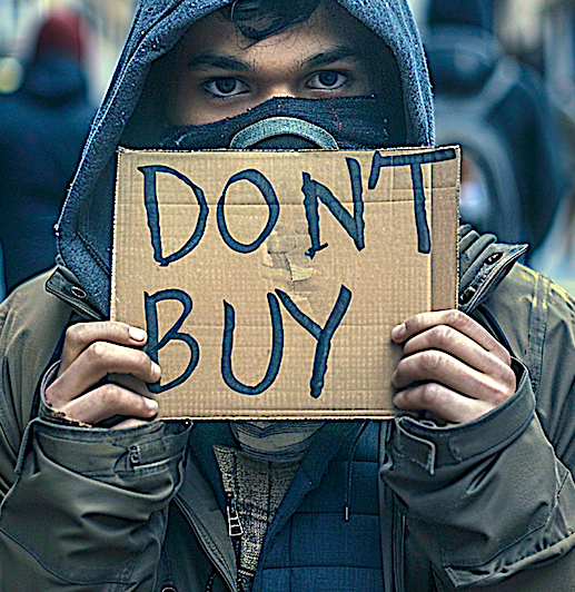 Man holding a sign that says, "Don't Buy." Image produced using Midjourney