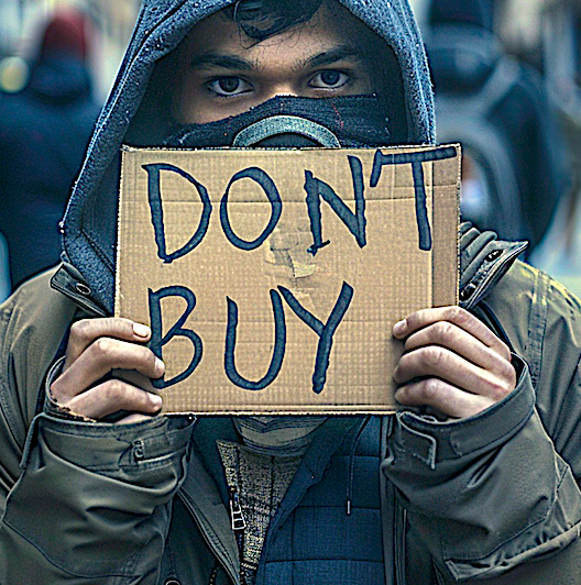 Man holding a sign that says, "Don't Buy." Image produced using Midjourney